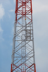 Telephone pole on blue sky background.