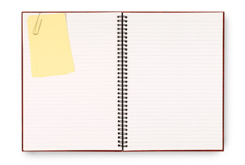 Writing book open showing pages with yellow sticky post it note attached photo
