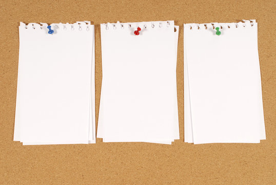 Bulletin board or cork notice baord background with untidy torn notepaper photo
