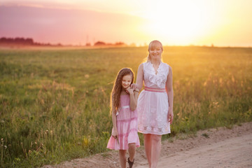 Mother and daughter at sunset