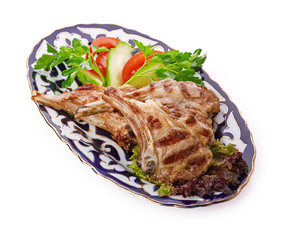 Meat on a grill with vegetables