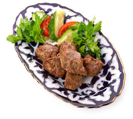 Meat on a grill with vegetables