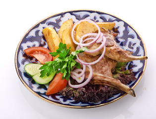 Meat on a grill with vegetables