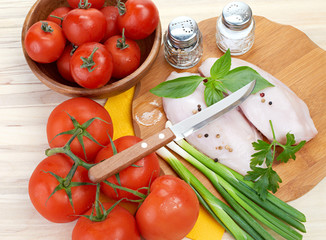Raw chicken breasts on cutting board