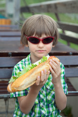 the boy in sunglasses with a great sandwich