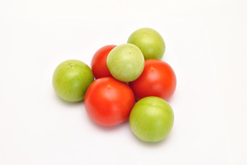 Pyramid of fresh green and red tomato on white background