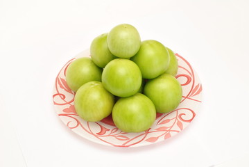 Pyramid of fresh green tomato on white background