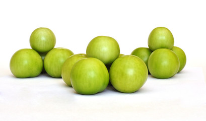 Pyramid of fresh green tomato on white background
