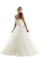 Fototapeta na wymiar Cheerful bride posing in fashionable wedding dress