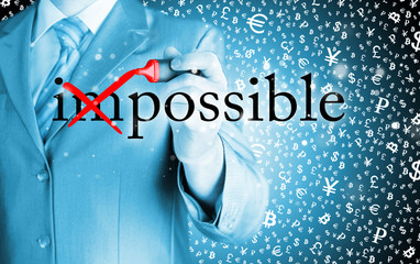 Businessman Hand turning the word Impossible into Possible with