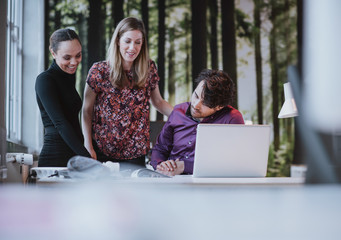 Team of young professionals viewing a catalogue