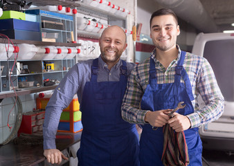 Workmen in auto repair shop
