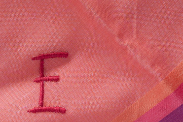 letter E embroidered on a handkerchief - obrazy, fototapety, plakaty