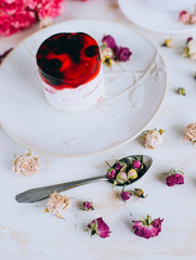 Still life with herbal tea, cake and roses on wooden background