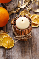 Candle decorated with cinnamon sticks