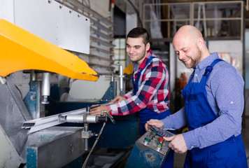 Two workmen in PVC shop