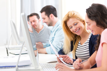 Young attractive people working together at the office