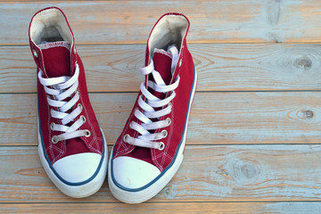 red canvas sneakers on a old wooden background