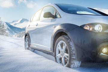 Fototapeta na wymiar SUV car on snow covered mountain road