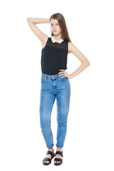 Young fashion girl in jeans posing isolated