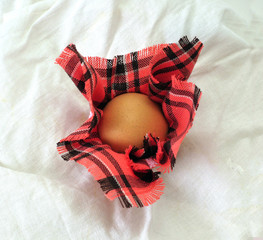 Egg, wrapped in a checkered napkin