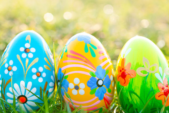 Handmade Easter eggs on grass. Spring patterns art, unique.