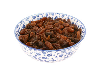 Sultanas in a blue and white china bowl