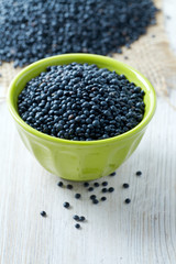 black lentils on table in bowl