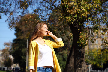 Happy beautiful woman calling by phone