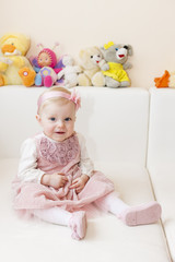 sitting toddler girl wearing pink dress