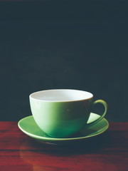 cup of coffee on the wooden desk
