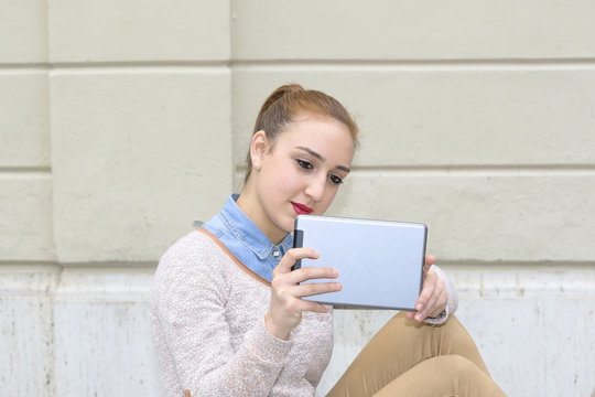 Young woman photograph using tablet - Powered by Adobe