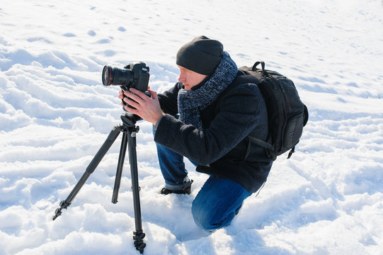 Male Photographer With A Tripod In Winter