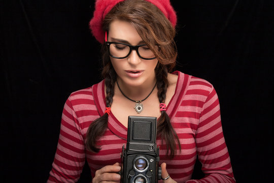 Young Woman Capturing Photo Using Vintage Camera