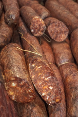 Smoked sausages meat in domestic smokehouse.