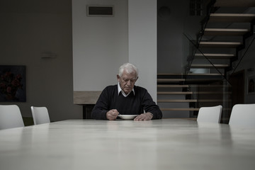 Elderly man eating dinner
