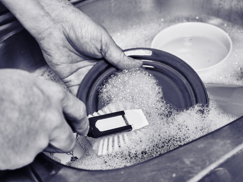 Man Washing A Dishes