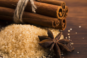 Cinnamon sticks with pure cane brown sugar on wood background