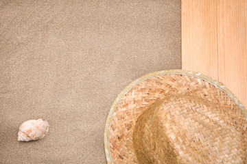 Shell and summer hat on sand	