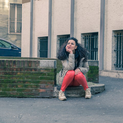 Beautiful young brunette posing in the city streets