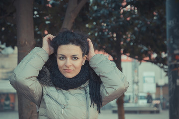 Beautiful young brunette posing in the city streets