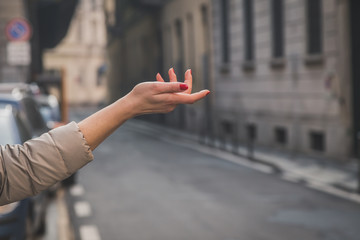 Female hand pointing in the city streets