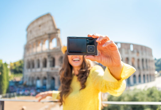 Closeup on happy young woman making selfie in front of colosseum