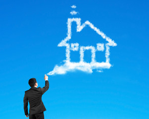 Businessman spraying house shape cloud paint with blue sky