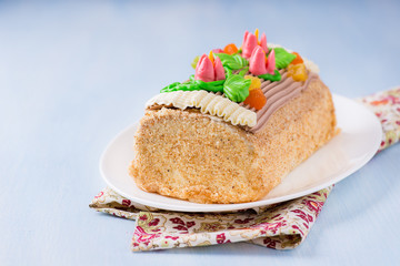 Roulade cake, decorated with colourful buttercream flowers