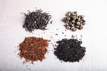 Four kinds of tea on a paper background