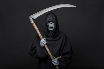 Death with scythe standing in the dark. Halloween