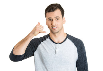 Handsome young man showing call me sign 