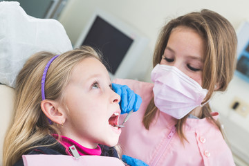 Little Girls Dentist and Patient During Dental Examination.