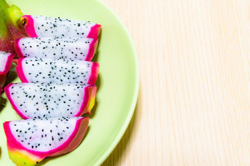 Dragon fruit (Pitaya) on dish with wood background